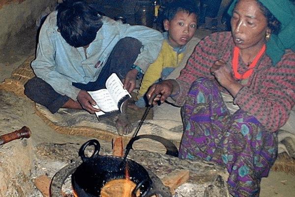 A group of people sitting around a fire.