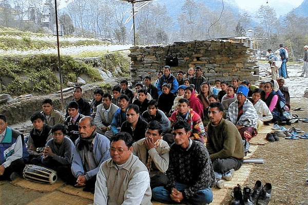 A group of people sitting on the ground.