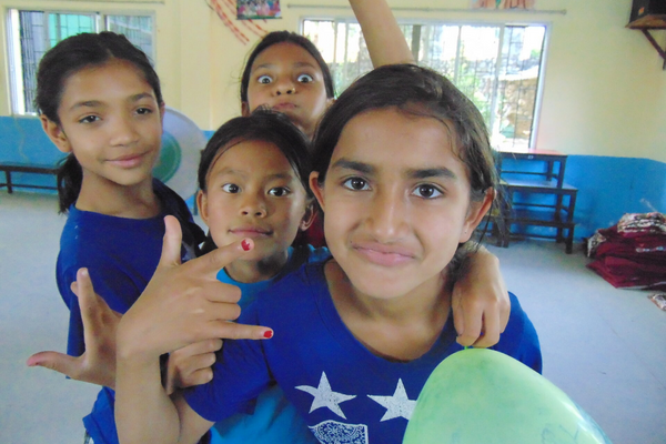 A group of young girls posing for the camera.