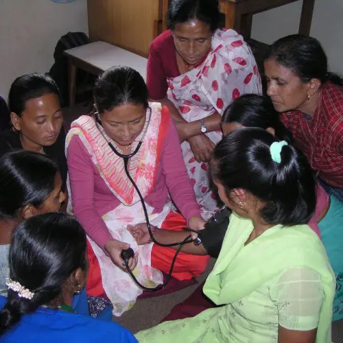 A group of women gathered around each other.