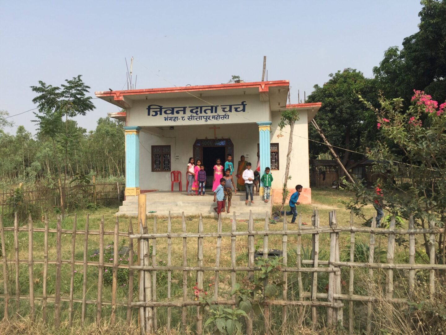 A group of people standing outside of a building.