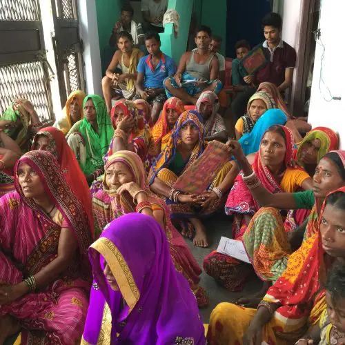 A group of women sitting in front of each other.