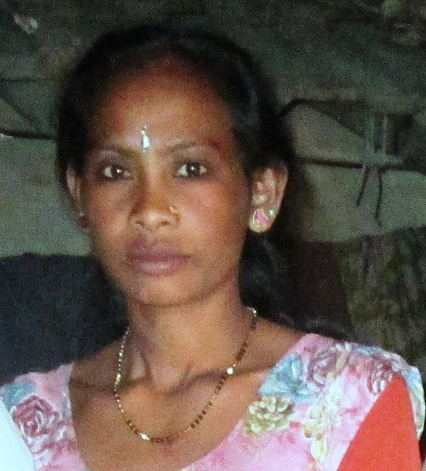 A woman with long hair and a necklace.